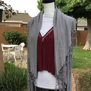 Sleeveless, long boho sweater with tassels